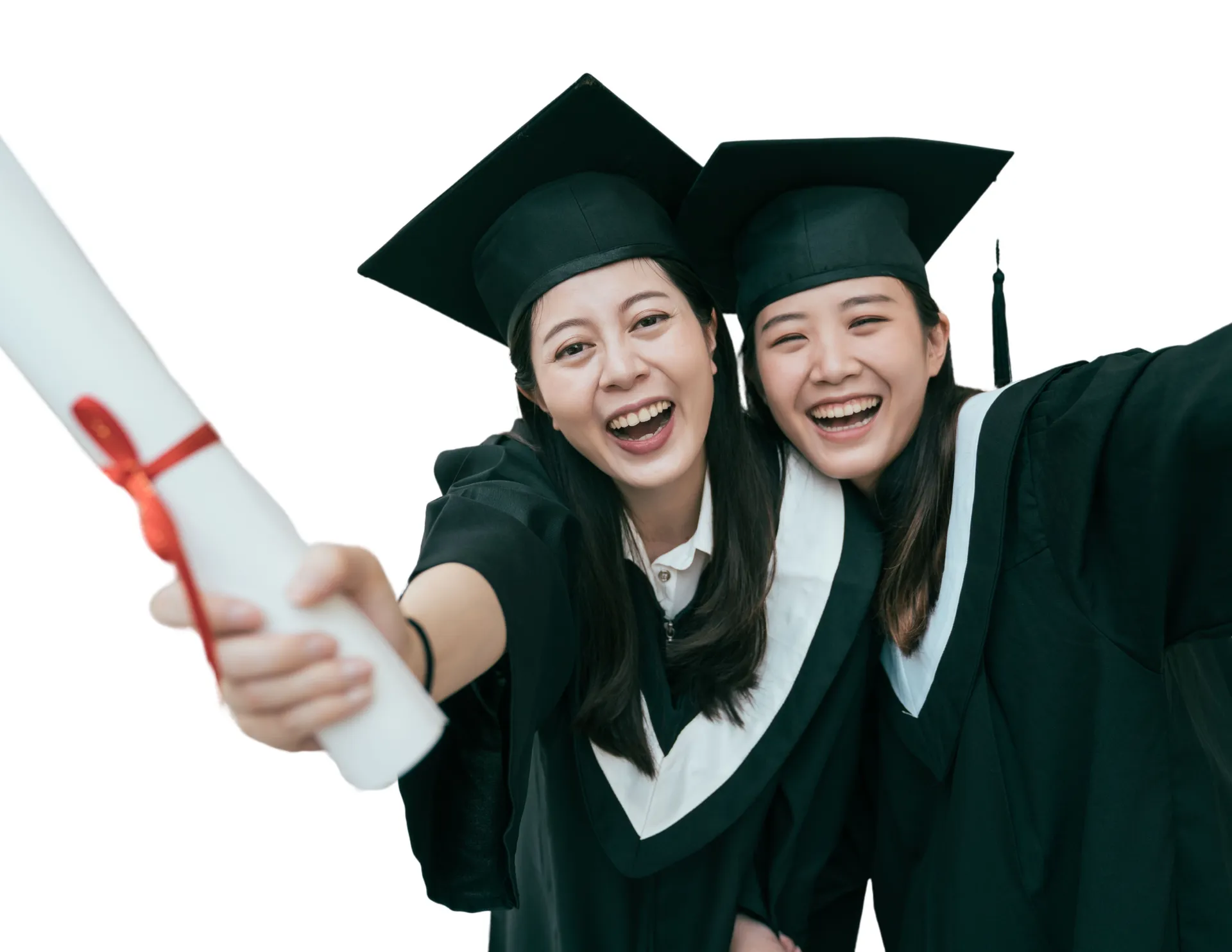 Two graduates in caps and gowns celebrating with a diploma