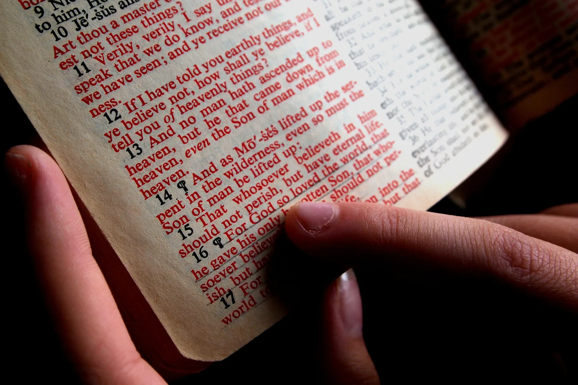 Hands turning the pages of a Bible